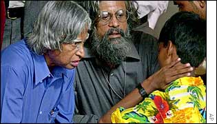 President AP J Abdul Kalam listens to a riot victim during Gujarat tour