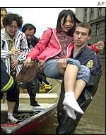 Japanese tourist is lifted from boat by rescue worker