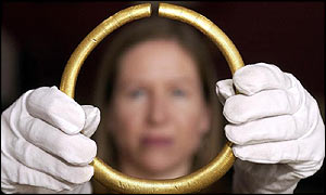 Lisa Voden-Decker, an employee of the British Museum displays a Bronze Age Torc