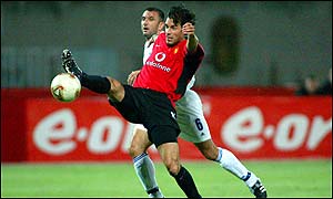 Manchester United striker Ruud van Nistelrooy battles for the ball