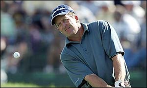 Fred Funk chips on to the 18th green during his first round at Hazeltine