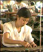 A woman works in a sewing factory in 1991