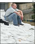 Dresden resident sitting on sandbags