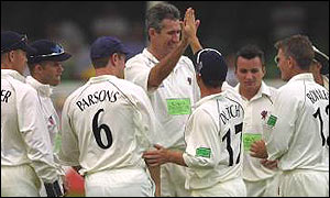 Andrew Caddick celebrates with Somerset team-mates