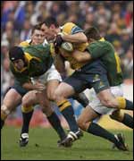 Australia's Daniel Herbert's charge is halted by South Africa's De Wet Barry