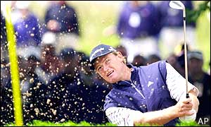 Ernie Els plays out of a bunker on the first hole in his third round