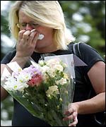 Woman lays flowers at Soham church