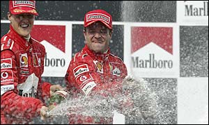 Rubens Barrichello and Michael Schumacher celebrate Ferrari's constructors title 