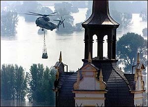 Helicopter carries sandbags near Hartenfels castle, Torgau (AFP)