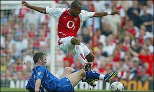 Damien Johnson of Birmingham City thwarts another Arsenal attack led by Ashley Cole