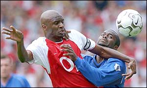 Arsenal's Patrick Vieira holds-off the challenge of Birmingham's Stern John