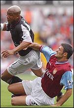 Villa's Alpay Ozalan tackles Liverpool's El Hadji Diouf