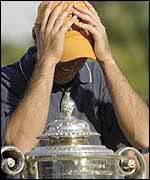 Rich Beem holds his head in his hands after winning the USPGA 