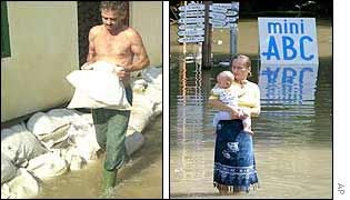 Man builds flood defences in Dunabogdany and woman holds child in Szentendre. AP