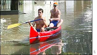 People use boats to reach flooded homes in Dunabogdany, Hungary. AP
