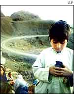 Afghan boy holding pet bird AP