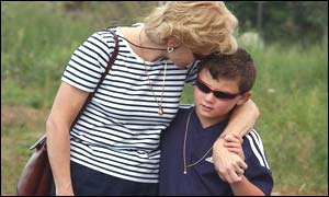 Well-wishers look at flowers left at the site near RAF Lakenheath
