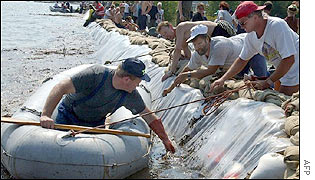 People inspect a dam at the Goitzsche lake near Bitterfeld, in Germany