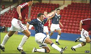 Peter Canero slots home the equalising goal for Scotland