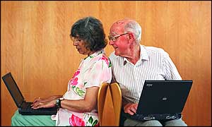 Man and woman with laptops