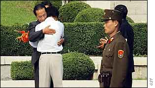 Ri Kyong-song hugs a North Korean official 