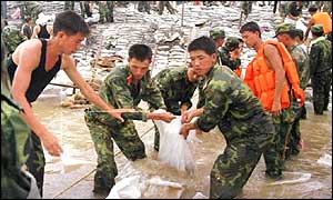 Chinese soldiers laying sandbags