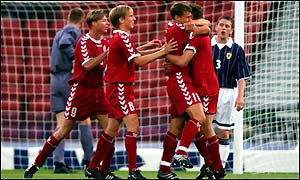 Denmark's Ebbe Sand is congratulated by team-mates after putting his side ahead