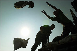 Soldiers throw sandbags in early morning work to secure the Elbe dyke in Lower Saxony