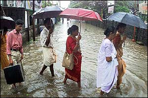 Pedestrians wade in the south-western Indian city of Cochin