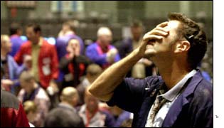 Trader clutches his hand