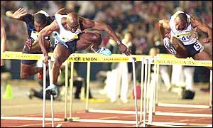 Allen Johnson (left) dominates proceedings in the men's 110m hurdles