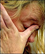 Woman cries on seeing the floral tributes