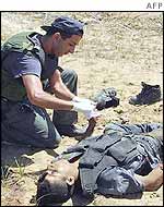 Israeli official checks body of Palestinian militant in Gaza