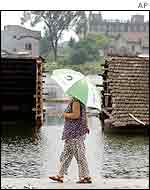 Woman walks along dyke in Hunan