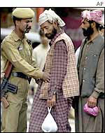 Policeman carries out security search in Rajouri