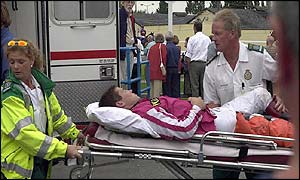 Jockey Richard Johnson is stretchered off to hospital after breaking his leg