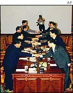 North and South Korean delegates greet each other
