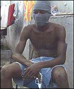 A Yardie in Jamaica displays his gun