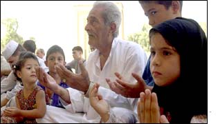 Children pray at a mosque in Baghdad