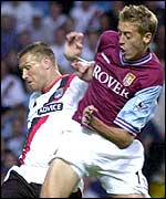 Aston Villa striker Peter Crouch challenges Manchester City's Steve Howey 