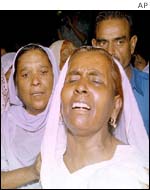 Grieving relatives at the scene of the attack on a missionary hospital