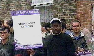 An asylum seeker protests against racist attacks