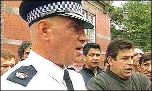 A policeman talks to asylum seekers in Sunderland