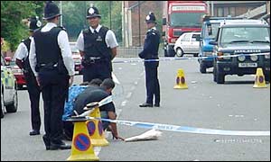 Grief: The cousins of Tayman Bahmani lay flowers where he fell
