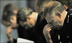 Cambridgeshire Police Asst Chief Constable Keith Hoddy bows his head in prayer 