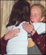 Two friends hug at the cathedral service