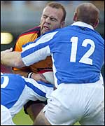 Andy Marinos feels the pain as Gareth Thomas challenges