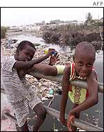 Senegalese children play near a polluted canal