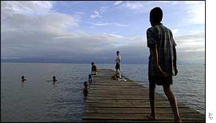 Children playing in Izabal Lake, Guatemala, which is rapidly becoming polluted