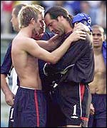 David Beckham comforts David Seaman after the goalkeeper's blunder against Brazil